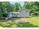 Rear exterior featuring a large backyard with luscious green trees and lawn at 270 Hunt Ridge Dr, Stockbridge, GA 30281