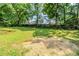 Large backyard featuring a lush lawn with shade trees and wooded back at 270 Hunt Ridge Dr, Stockbridge, GA 30281