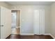 Bedroom with wood-look flooring, and access to an adjacent room and closet, enhancing functionality at 270 Hunt Ridge Dr, Stockbridge, GA 30281