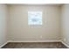 A clean, carpeted bedroom with neutral walls and a single window at 270 Hunt Ridge Dr, Stockbridge, GA 30281