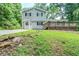 Charming two-story home with a wooden deck, gray siding, black shutters, and mature trees at 270 Hunt Ridge Dr, Stockbridge, GA 30281