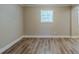 Bright living room featuring wood-look flooring and a window offering natural light at 270 Hunt Ridge Dr, Stockbridge, GA 30281