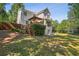 Expansive backyard featuring a deck with pergola, lush greenery, and ample space for outdoor activities at 5100 Sunset Maple Trl, Lilburn, GA 30047