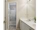 Bright bathroom vanity with double sinks, ample lighting, and shower at 5100 Sunset Maple Trl, Lilburn, GA 30047