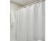 Bathroom featuring a striped shower curtain, white tile, and clean fixtures at 5100 Sunset Maple Trl, Lilburn, GA 30047