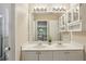 Bathroom featuring double sinks, framed mirror, cabinetry, and lots of counter space at 5100 Sunset Maple Trl, Lilburn, GA 30047