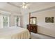 Traditional primary bedroom with a ceiling fan, windows, and neutral carpet at 5100 Sunset Maple Trl, Lilburn, GA 30047