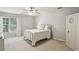 This bedroom features a window, white walls, ceiling fan, and ample closet space at 5100 Sunset Maple Trl, Lilburn, GA 30047