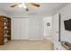 Cozy bedroom features a ceiling fan, closet and access to another room at 5100 Sunset Maple Trl, Lilburn, GA 30047
