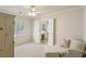 Spacious bedroom with a window, lounge chair, and open access to the bathroom at 5100 Sunset Maple Trl, Lilburn, GA 30047