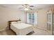 Bright bedroom with a large window, ceiling fan, and neutral décor at 5100 Sunset Maple Trl, Lilburn, GA 30047