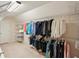 Spacious walk-in closet with ample storage, featuring metal shelving for organization and a variety of colorful clothing at 5100 Sunset Maple Trl, Lilburn, GA 30047