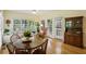 Inviting dining area features large windows, wood floors and a traditional china cabinet at 5100 Sunset Maple Trl, Lilburn, GA 30047