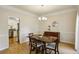 Inviting dining room featuring hardwood floors, neutral walls, and elegant trim, perfect for Gathering gatherings at 5100 Sunset Maple Trl, Lilburn, GA 30047
