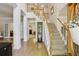 Inviting foyer with hardwood floors and a staircase, creating an elegant and open entrance to the home at 5100 Sunset Maple Trl, Lilburn, GA 30047