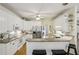 Spacious kitchen features ample counter space, white cabinetry and stainless steel appliances at 5100 Sunset Maple Trl, Lilburn, GA 30047