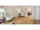 Cozy living room with hardwood floors, featuring a view into another room through elegant french doors at 5100 Sunset Maple Trl, Lilburn, GA 30047