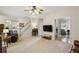 Spacious and inviting living room with plush carpeting and a view into the open kitchen area at 5100 Sunset Maple Trl, Lilburn, GA 30047