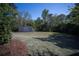Serene backyard featuring a shed, lush lawn, and mature trees at 6165 Namon Wallace Dr, Cumming, GA 30028