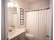 Bright bathroom featuring a vanity, toilet, and shower with white shower curtain at 6165 Namon Wallace Dr, Cumming, GA 30028