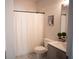Bright bathroom with a shower, gray vanity, and tile floors at 6165 Namon Wallace Dr, Cumming, GA 30028