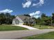 Beautiful home with a well-kept lawn, and a large driveway leading to a three-car garage at 6165 Namon Wallace Dr, Cumming, GA 30028