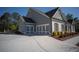 Charming home features a three-car garage and a well-maintained lawn, and brick accents at 6165 Namon Wallace Dr, Cumming, GA 30028