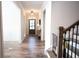 Inviting foyer featuring hardwood floors, neutral walls, and elegant lighting fixtures at 6165 Namon Wallace Dr, Cumming, GA 30028