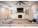 Inviting living room featuring a brick fireplace with custom built-ins and stylish decor at 6165 Namon Wallace Dr, Cumming, GA 30028