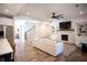 Open-concept living room with fireplace, built-ins, hardwood floors, and staircase at 6165 Namon Wallace Dr, Cumming, GA 30028