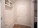 Functional mudroom with built-in bench, storage shelves, and convenient access to laundry at 6165 Namon Wallace Dr, Cumming, GA 30028