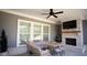 Cozy outdoor patio with a fireplace, TV, stylish seating, and natural light at 6165 Namon Wallace Dr, Cumming, GA 30028
