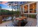 Inviting back deck with outdoor seating, screened porch, and scenic lake views at twilight at 1141 Ragley Hall Ne Rd, Brookhaven, GA 30319
