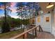 Beautiful back deck at dusk overlooking the lake with cable railings and white siding at 1141 Ragley Hall Ne Rd, Brookhaven, GA 30319
