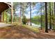 View from the house, showcasing a serene backyard with lake access and mature trees at 1141 Ragley Hall Ne Rd, Brookhaven, GA 30319