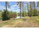 Lush backyard with mature trees and lake views at 1141 Ragley Hall Ne Rd, Brookhaven, GA 30319