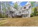 Expansive backyard view with a multi-level deck, screened porch, and lush lawn at 1141 Ragley Hall Ne Rd, Brookhaven, GA 30319