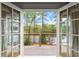 French doors opening to a private deck overlooking a serene lake at 1141 Ragley Hall Ne Rd, Brookhaven, GA 30319