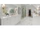 Bright bathroom featuring double vanity, glass shower, and herringbone floors at 1141 Ragley Hall Ne Rd, Brookhaven, GA 30319