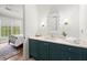 Bright bathroom featuring a modern vanity, decorative mirror, and view into adjacent bedroom at 1141 Ragley Hall Ne Rd, Brookhaven, GA 30319