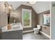 Stylish bathroom with a modern vanity, wood look flooring, and a serene view of the outdoors at 1141 Ragley Hall Ne Rd, Brookhaven, GA 30319