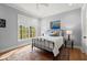 Cozy bedroom with a wrought iron bed frame and a picturesque view of the surrounding trees at 1141 Ragley Hall Ne Rd, Brookhaven, GA 30319