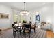 Bright dining room with hardwood floors, shiplap walls, and stylish chandelier at 1141 Ragley Hall Ne Rd, Brookhaven, GA 30319