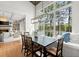 Dining room view to lake, has large windows, hardwood floors, and fireplace with sofas in the background at 1141 Ragley Hall Ne Rd, Brookhaven, GA 30319