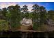 Stately lakefront home with mature trees, white exterior, and multiple stories at 1141 Ragley Hall Ne Rd, Brookhaven, GA 30319