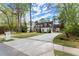 Beautiful front exterior of a white house with a long driveway and well-maintained yard at 1141 Ragley Hall Ne Rd, Brookhaven, GA 30319