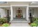 Inviting front porch with slate tile, white columns, and a warm-toned front door at 1141 Ragley Hall Ne Rd, Brookhaven, GA 30319