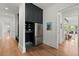 Hallway with built in cabinet storage, bench, stainless fridge, and view to living space at 1141 Ragley Hall Ne Rd, Brookhaven, GA 30319