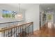 Bright hallway with hardwood floors, modern lighting, and views of the surrounding landscape at 1141 Ragley Hall Ne Rd, Brookhaven, GA 30319