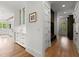 Hallway with built-in storage cabinets leading to a bright, modern kitchen at 1141 Ragley Hall Ne Rd, Brookhaven, GA 30319